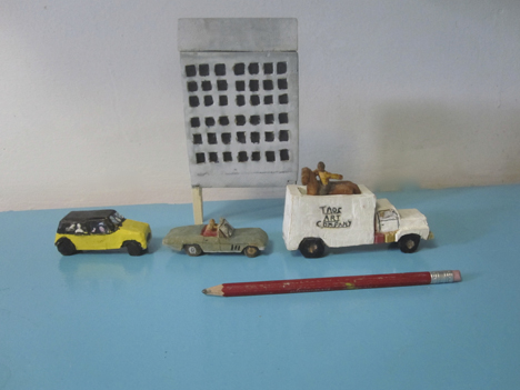jorge lovato sculptures created from wood minni cooper,corvette,truck and rider and a pencil showing the size of art work